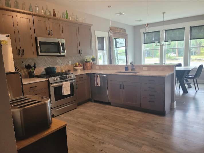 A kitchen with stainless steel appliances and wooden cabinets