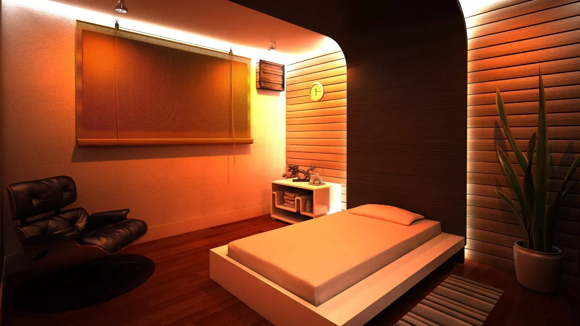 Um quarto moderno e com iluminação suave, com uma cama plataforma baixa, uma poltrona de couro preta e iluminação ambiente.