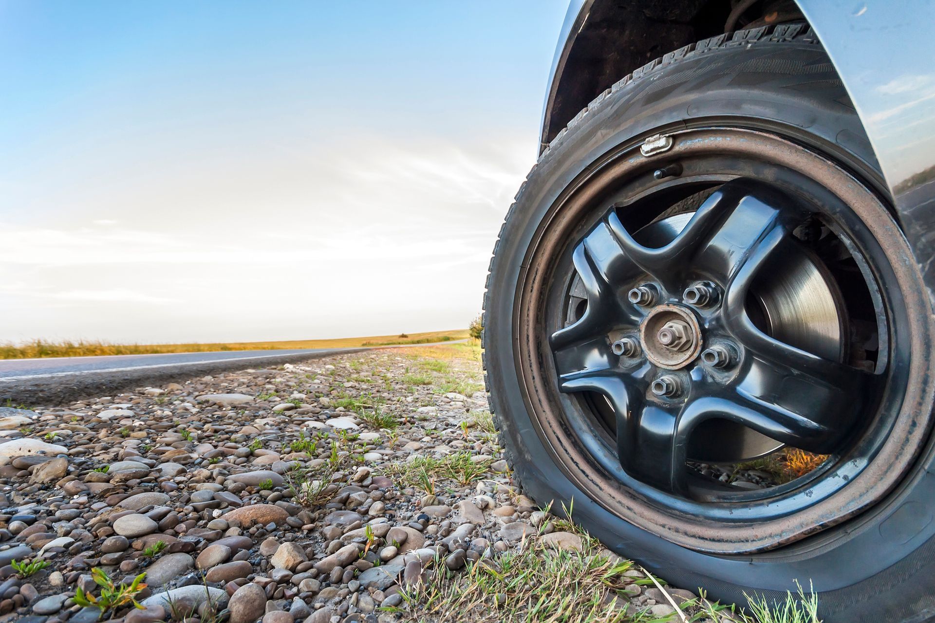 technician-repairing-punctured-suv-tire-on-site
