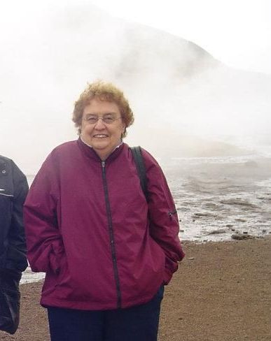 A woman in a purple jacket is standing next to a man in a black jacket.