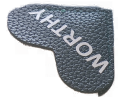A close up of a black heart shaped piece of leather with the word `` mirror '' written on it.