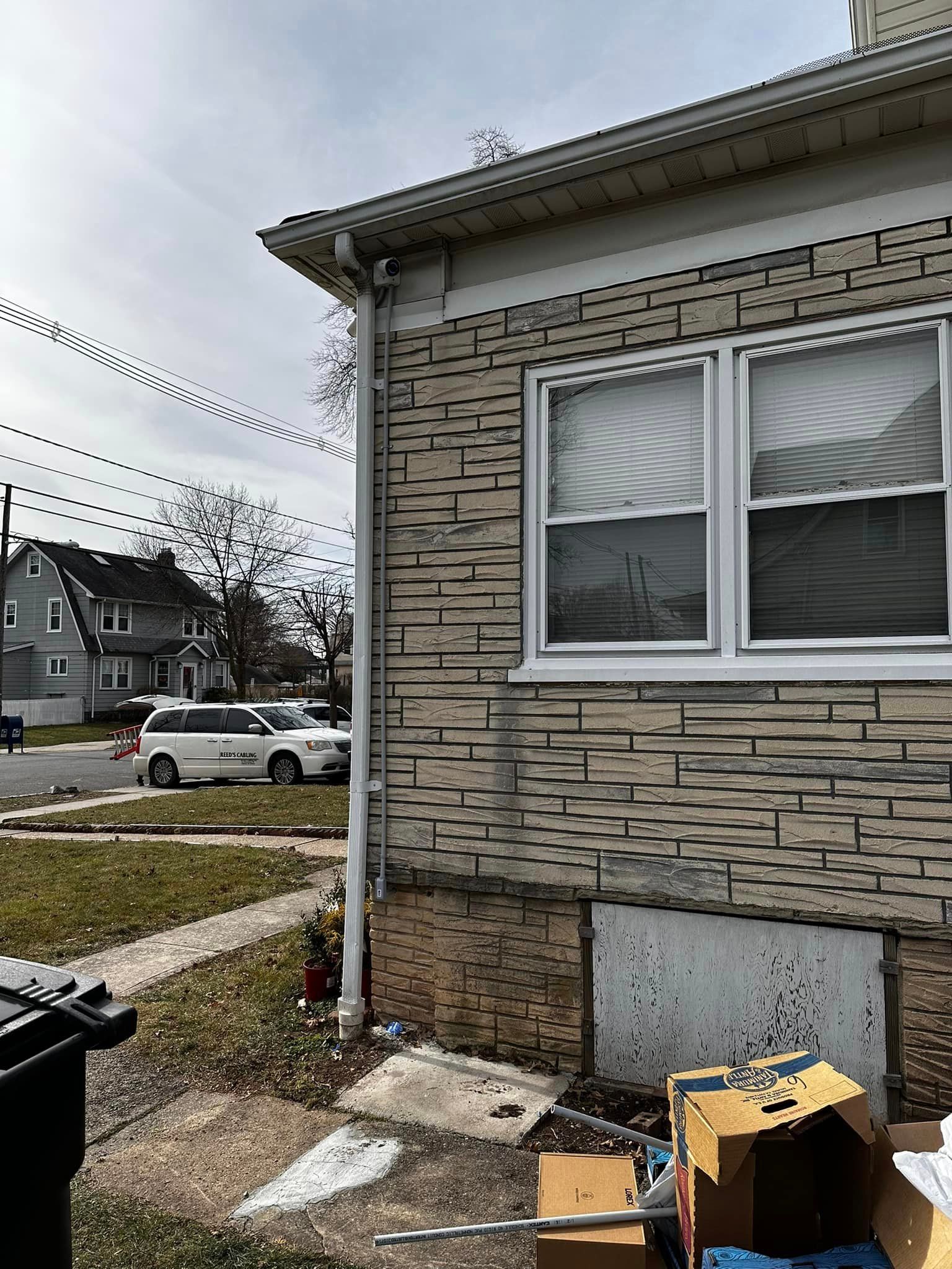 A brick house with a white van parked in front of it.