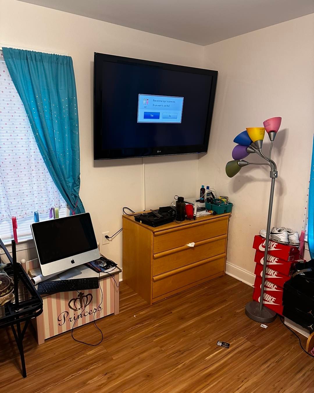 A bedroom with a large flat screen tv on the wall.
