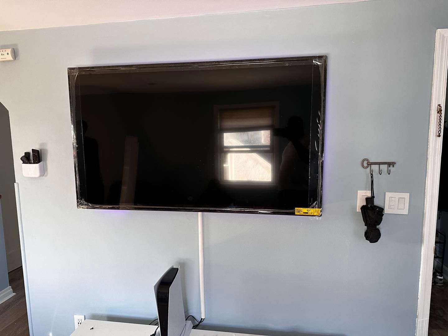 A flat screen tv is mounted on a wall in a living room.