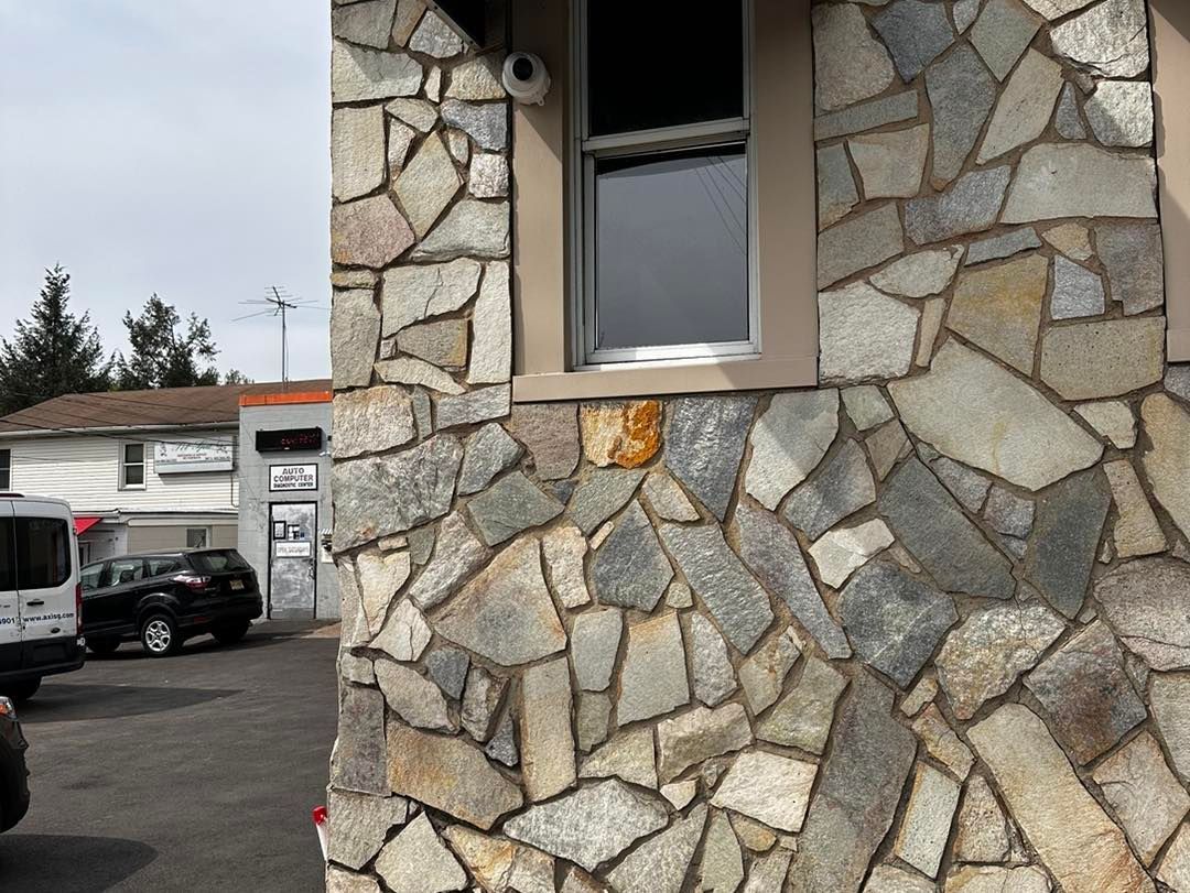 A building with a stone wall and a window