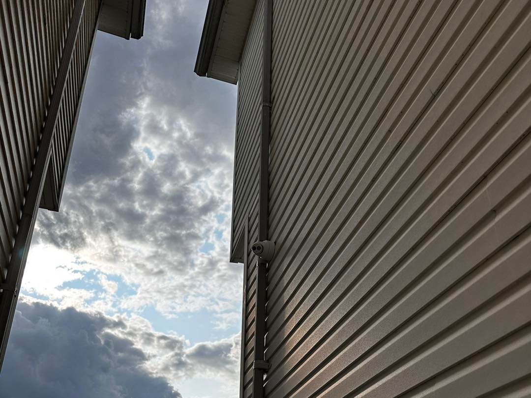 Looking up at a building with a cloudy sky in the background.