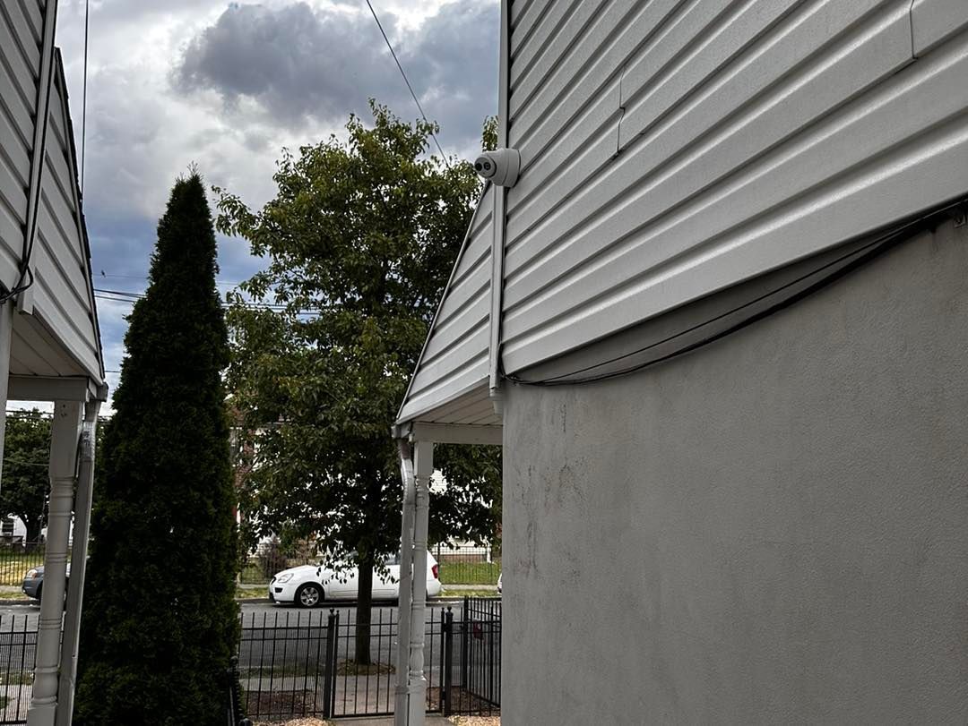 A white building with a tree in front of it