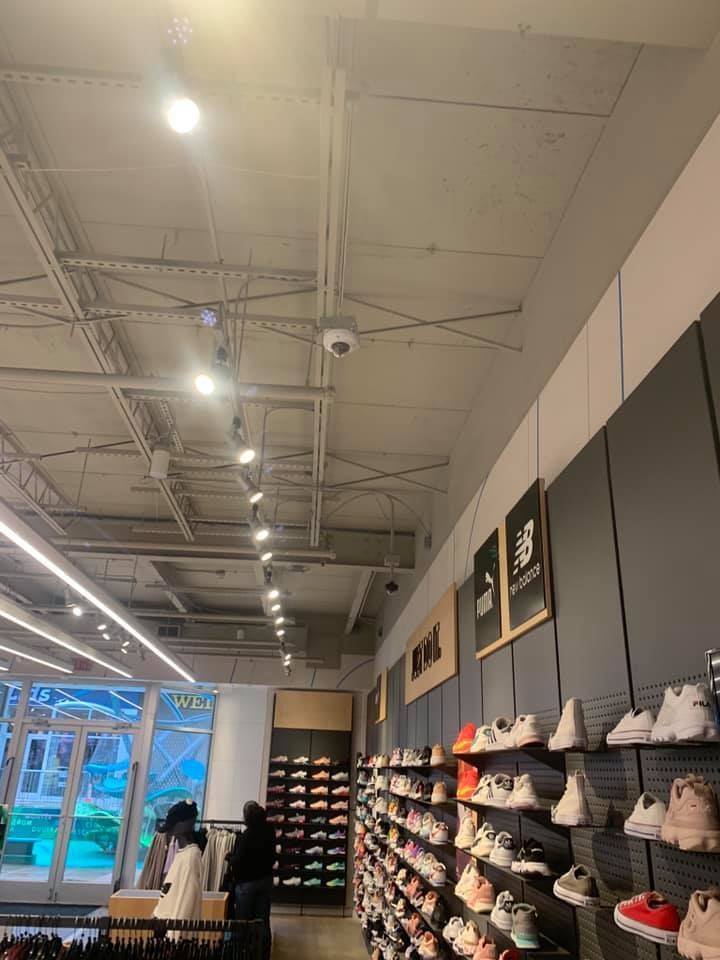 A shoe store with a lot of shoes on shelves.