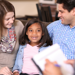 girl and her parents sitting together