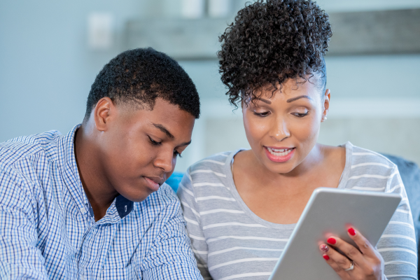 mother and son on tablet together