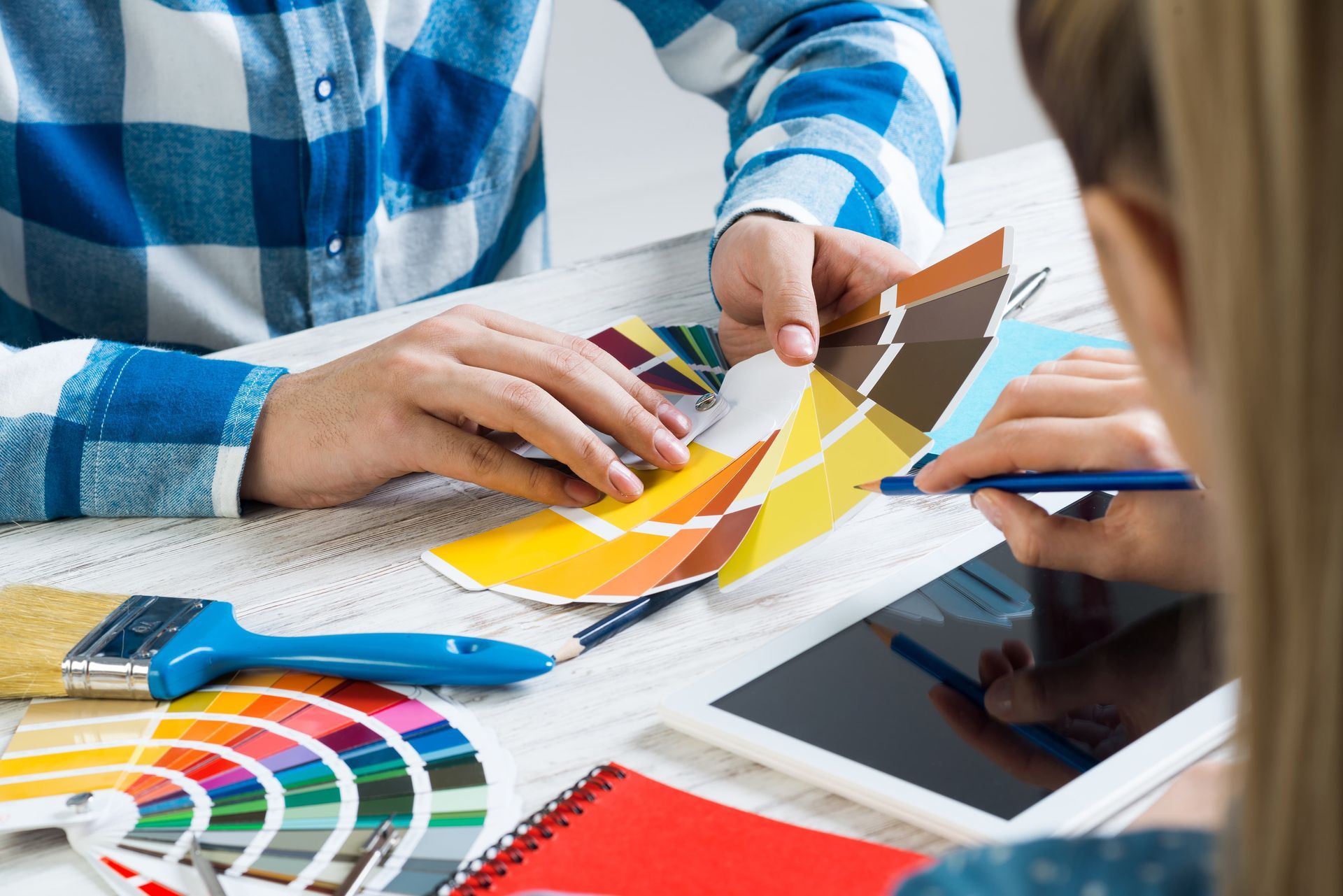 People reviewing color swatches and a tablet at a design meeting