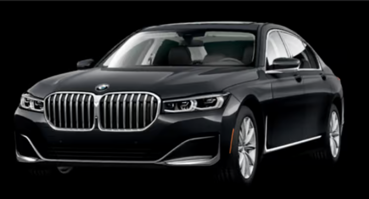 A black bmw 7 series is shown on a black background.