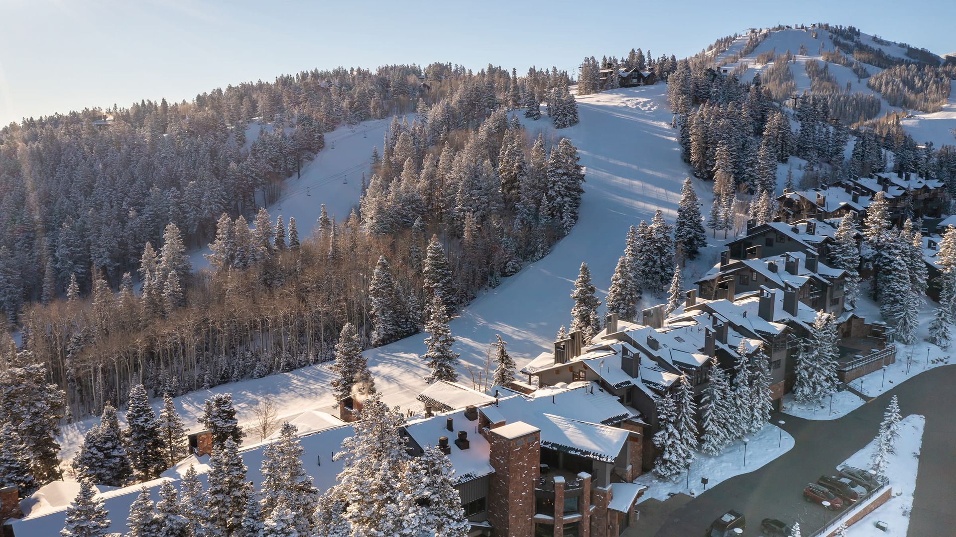 An aerial view of a ski resort with a snowy mountain in the background