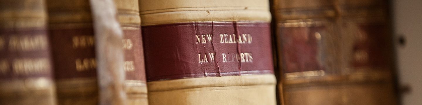 A row of law books sitting on top of each other on a shelf.