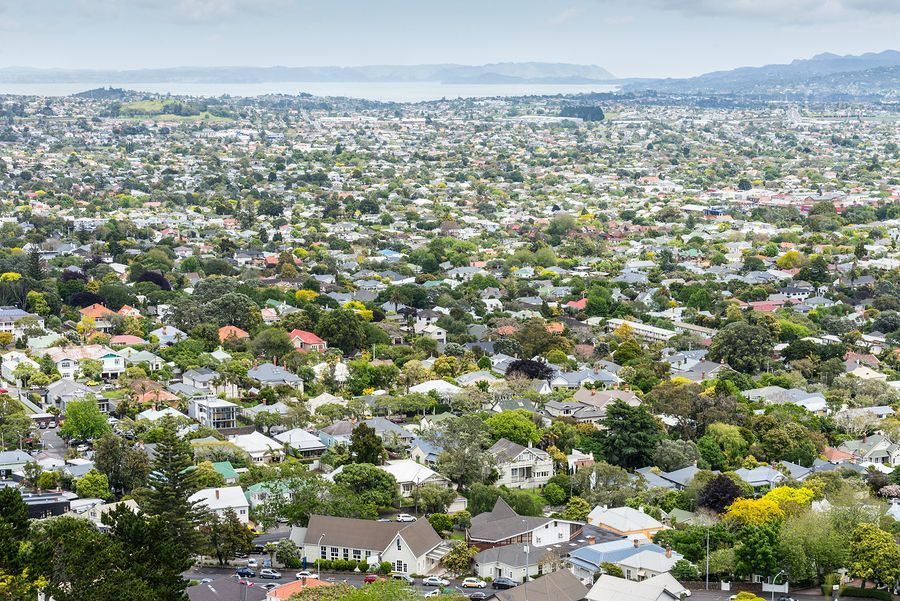 An aerial view of a city filled with lots of houses and trees.