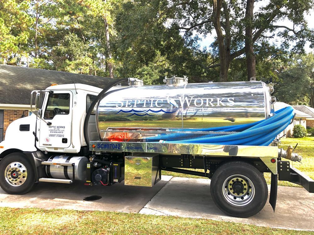 a septic works truck is parked in front of a house