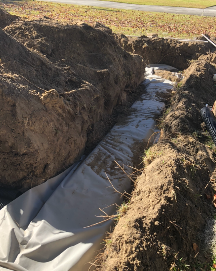 a large hole in the ground with a white tarp covering it