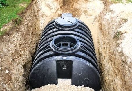 a septic tank is being installed in a trench .