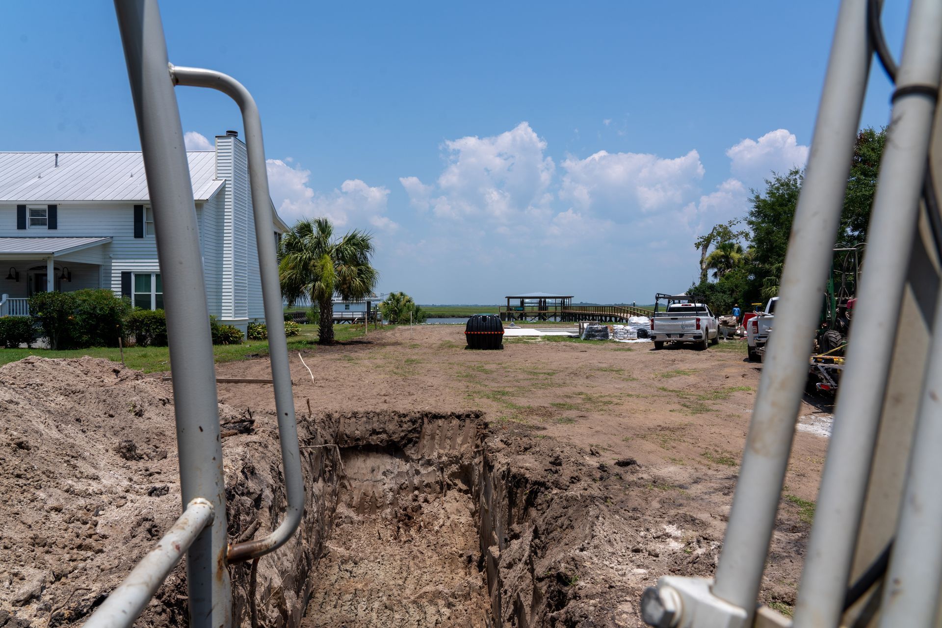a large hole in the ground in front of a white house