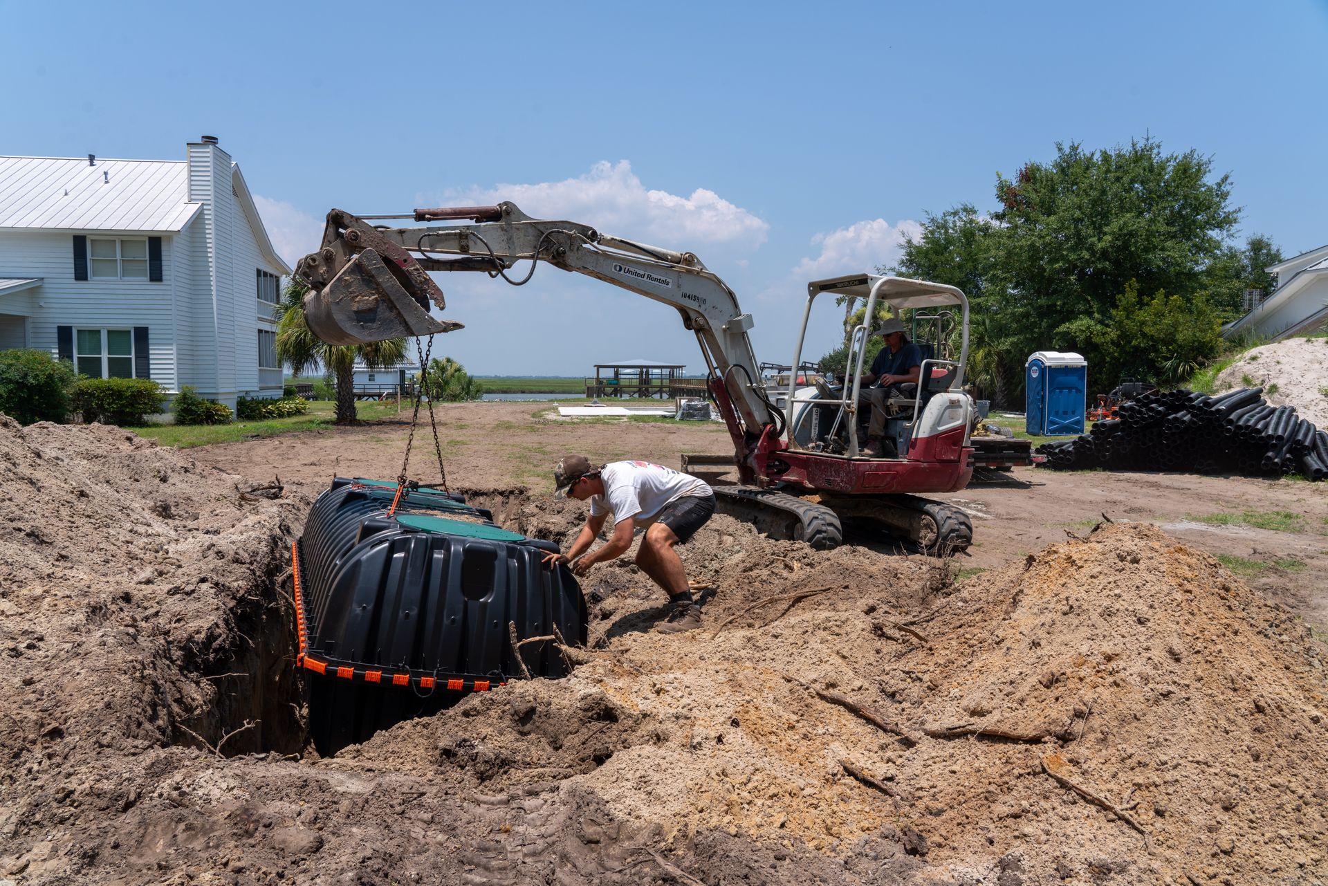 a man is working on a septic tank in the dirt