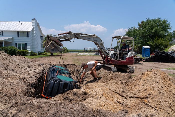 a man is driving an excavator that says takeuchi