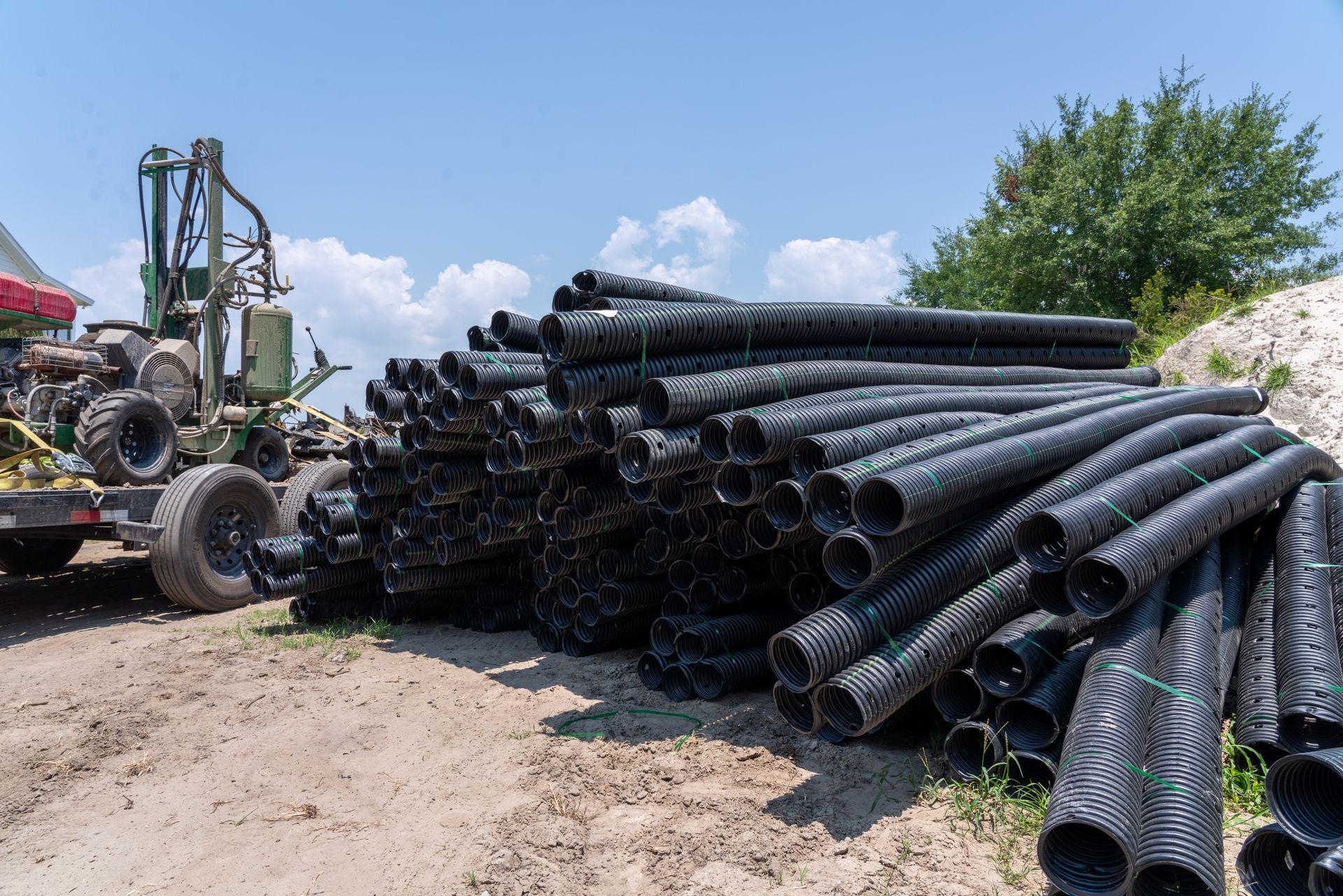 a bunch of black pipes are stacked on top of each other