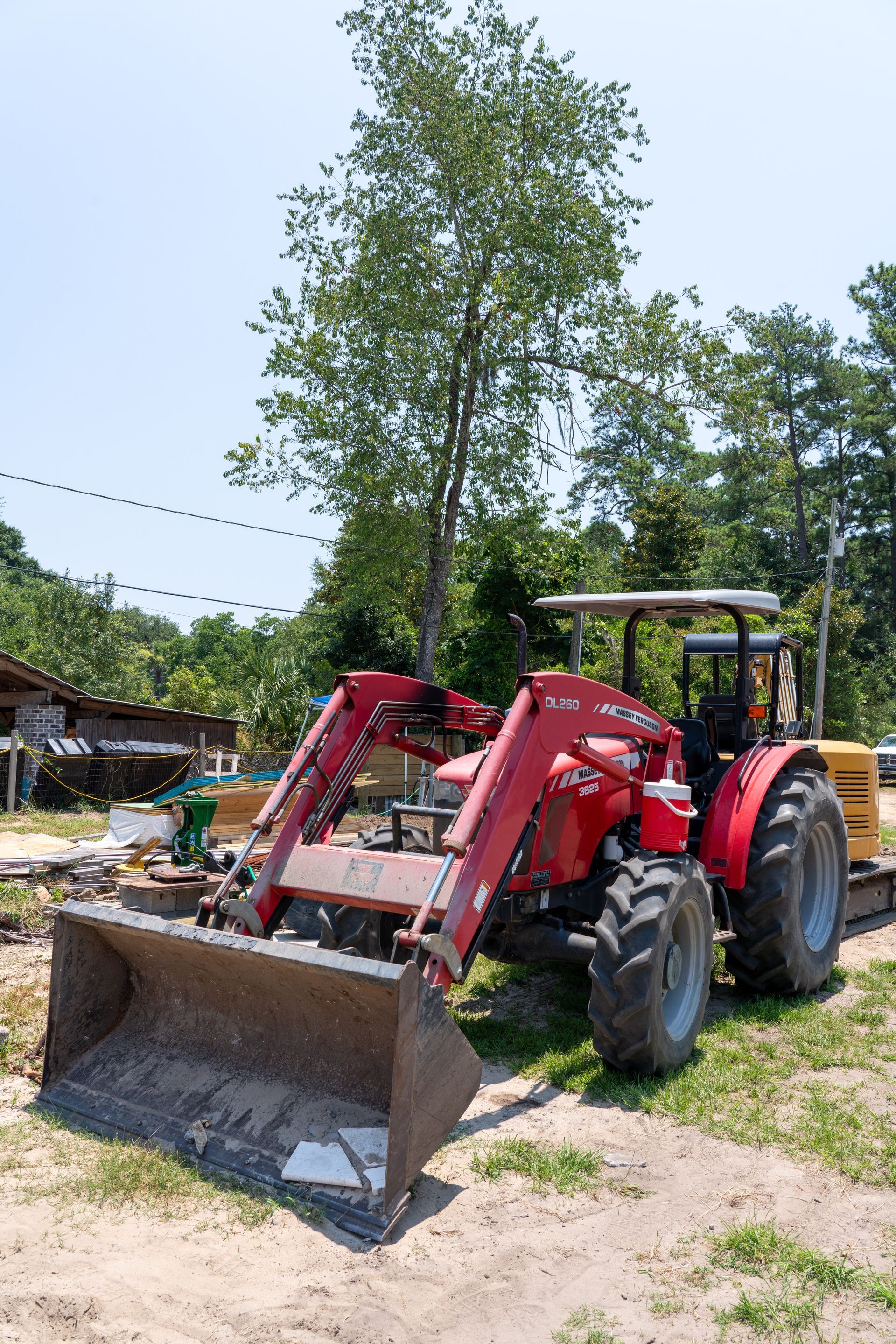 a red massey ferguson tractor is parked in a field