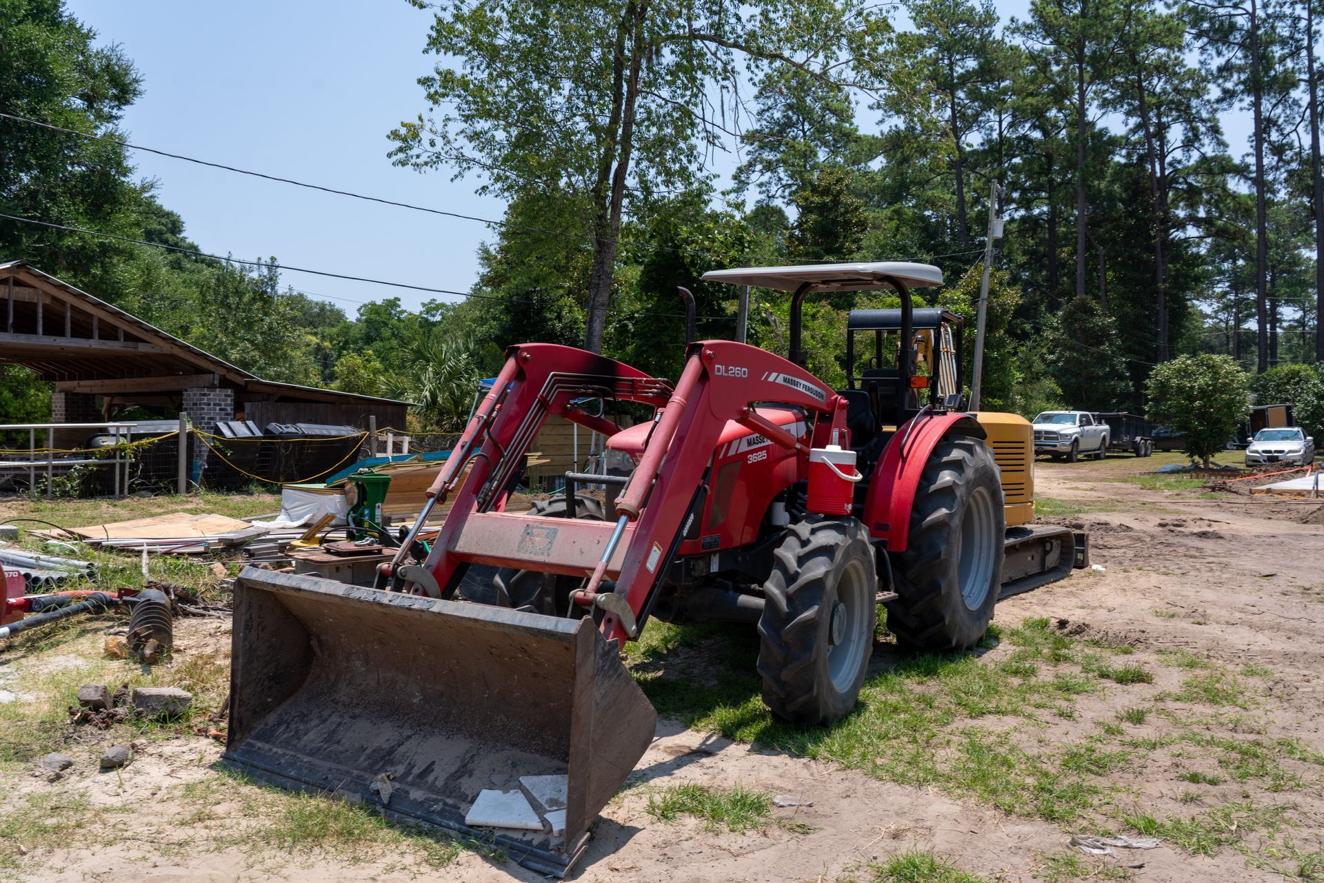 a red massey ferguson tractor is parked in the dirt