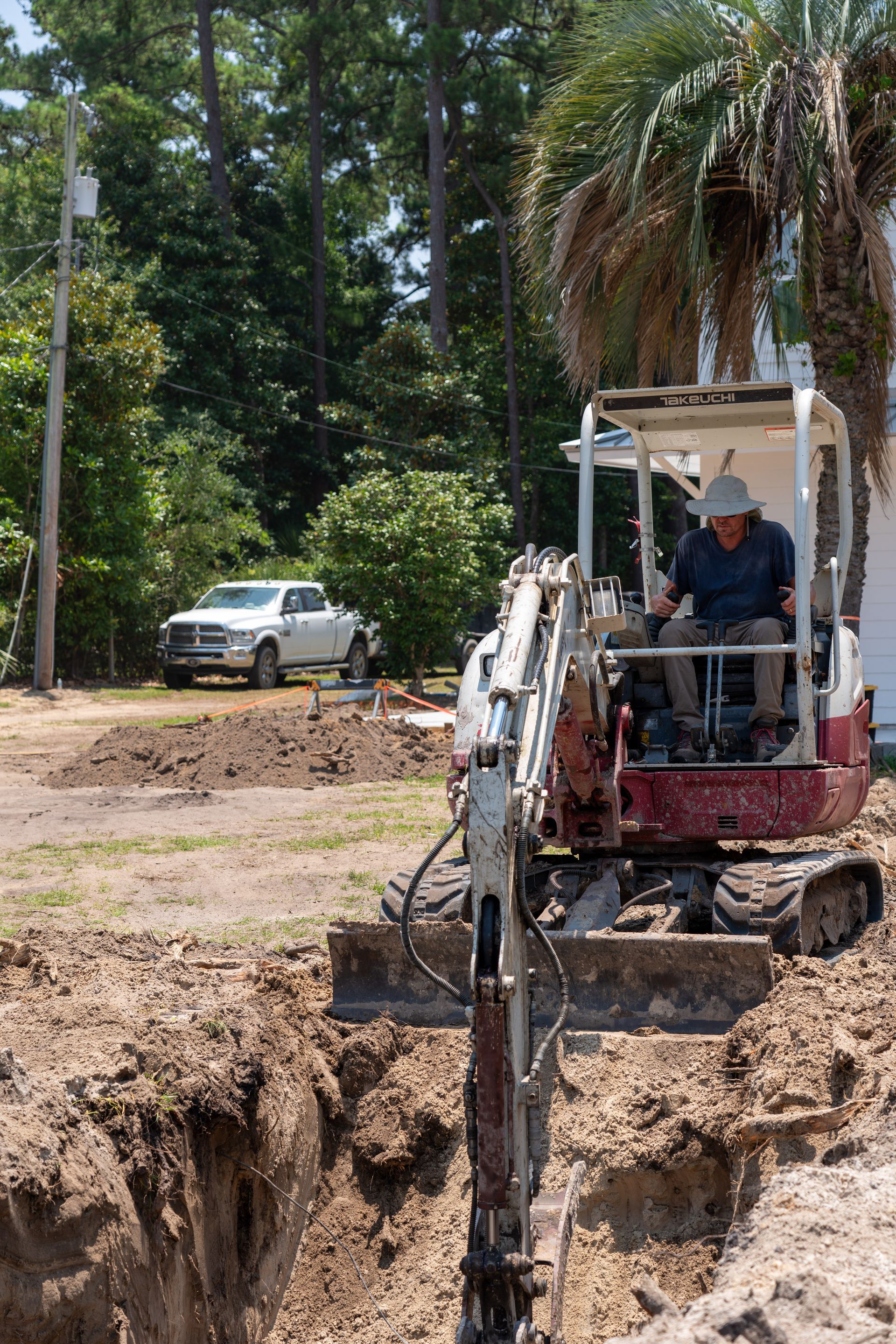 a man is driving an excavator that says takeuchi on the front