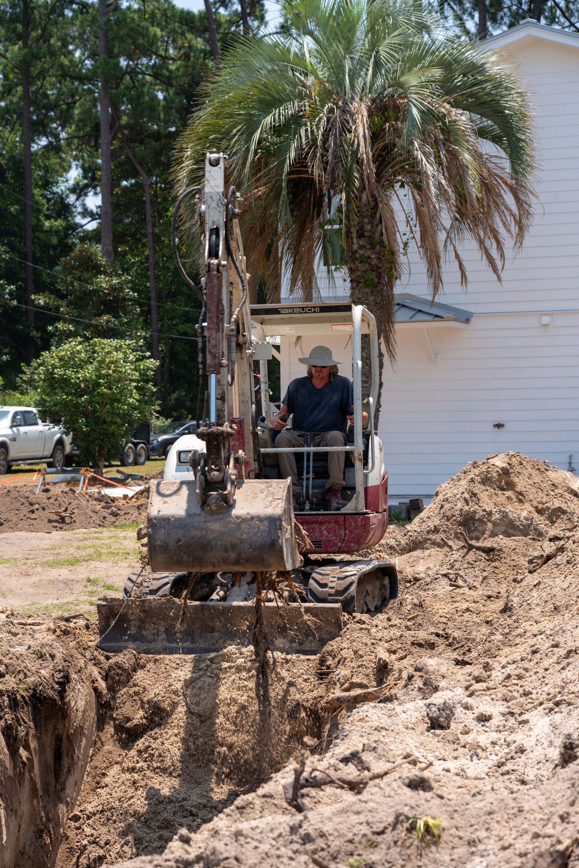 a man is driving an excavator that says takeuchi on the front