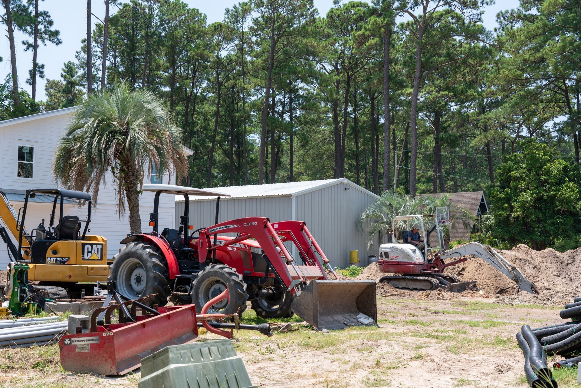a yellow cat tractor is parked in front of a house