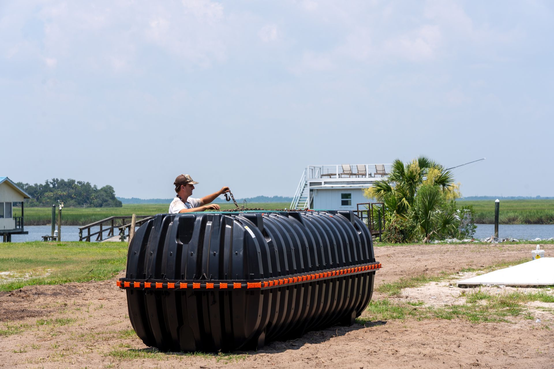 a man is standing next to a large black tank that says ' a ' on it