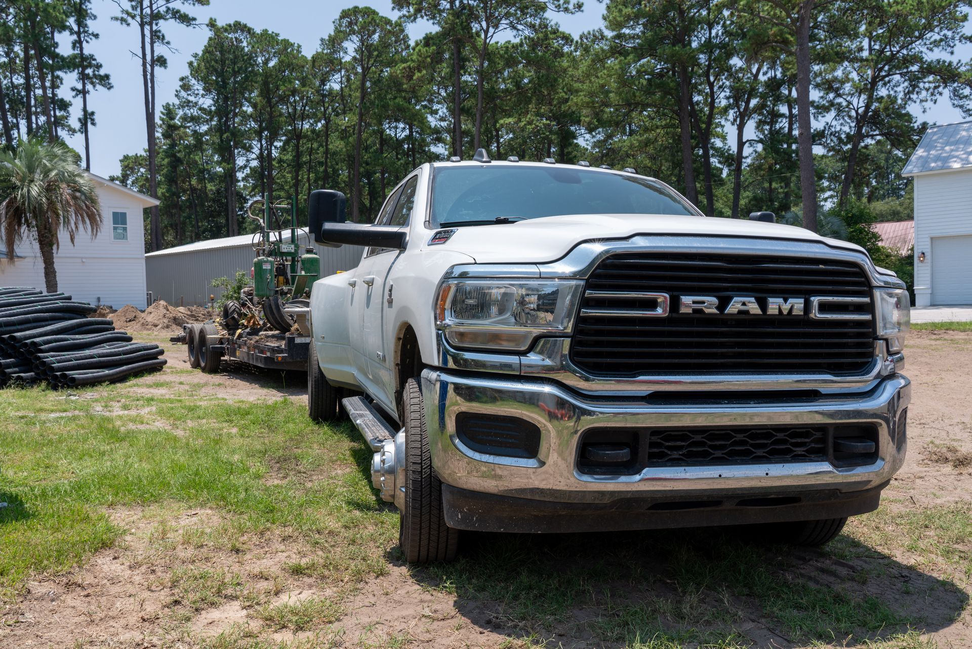 a white ram truck is parked in the grass