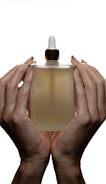 A Woman is Holding a Bottle of Perfume in Her Hands — Townsville Anti Aging in Currajong, QLD