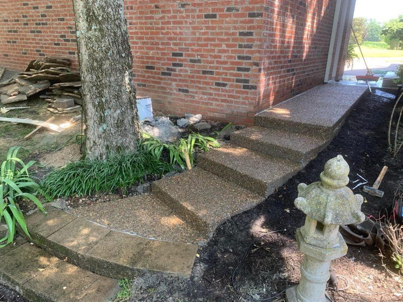 A brick building with stairs leading up to it and a fire hydrant in front of it.