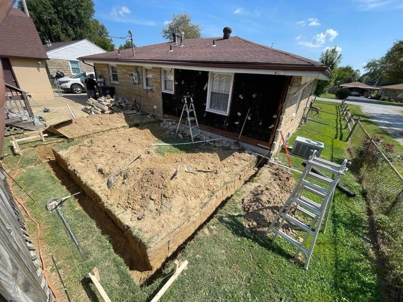 A large pile of dirt is sitting in front of a house.