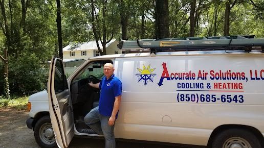 Man standing by white service van with open door, labeled Above Air Solutions HVAC, in a wooded area