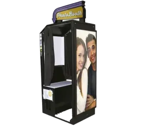 Photo booth with a couple's photo on the side. Dark exterior, purple "Photo Booth" sign.