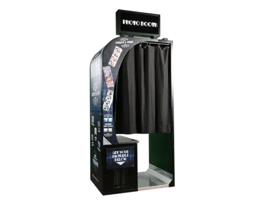 Photo booth with black curtains, signage, and a touchscreen interface.