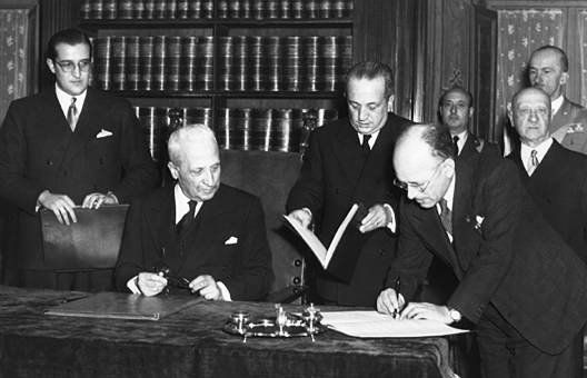 black and white photo of a man signing