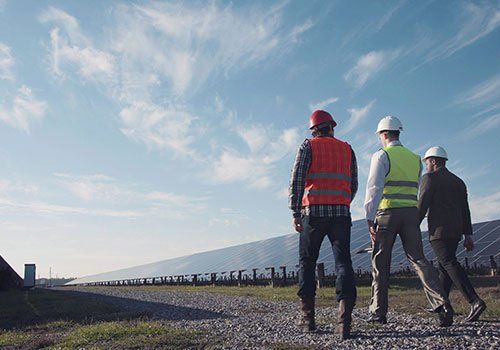 Workers Inspecting Solar Panel — Danville, IL — Schomburg & Schomburg Construction Incorporated