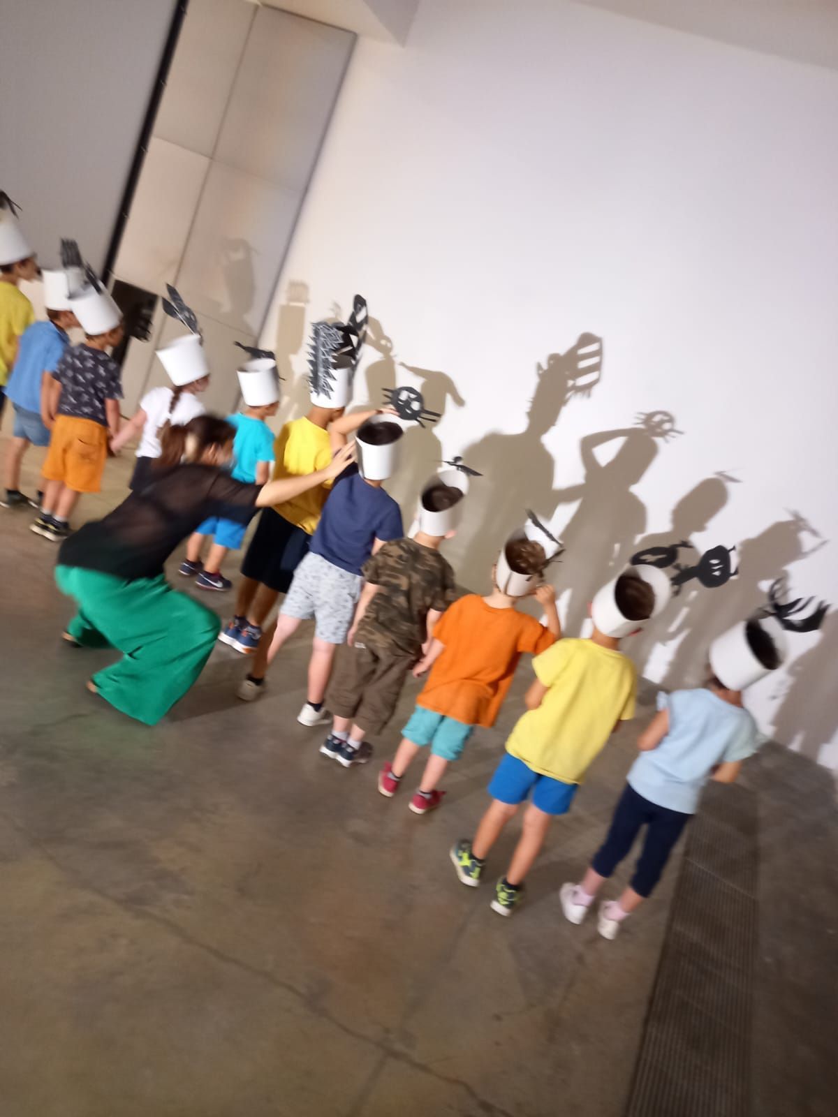 Un gruppo di bambini che indossano cappelli da cuoco sono in fila