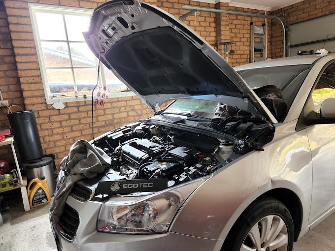 A Silver Car with Its Hood Open in A Garage — ACT Mobile Mechanics in Isaacs, ACT