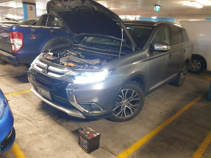 A Mitsubishi Outlander with Its Hood Open Is Parked in A Parking Garage — ACT Mobile Mechanics in Isaacs, ACT