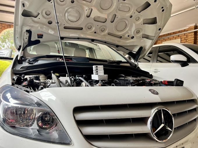 A White Mercedes Benz with The Hood Open — ACT Mobile Mechanics in Isaacs, ACT