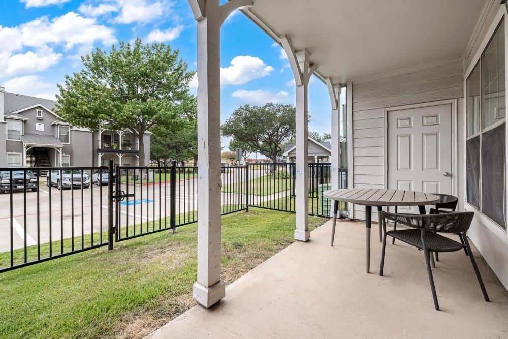 a table and chairs on the porch at Marquis at Lantana in Flower Mound, TX.