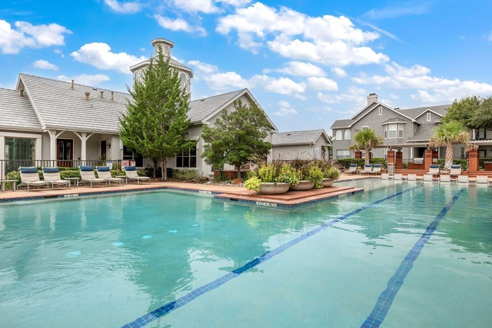 a large swimming pool in front of a building at Marquis at Lantana in Flower Mound, TX.