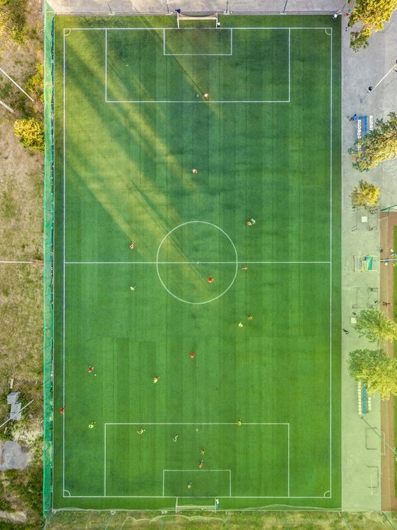 An aerial view of a soccer field with players on it.