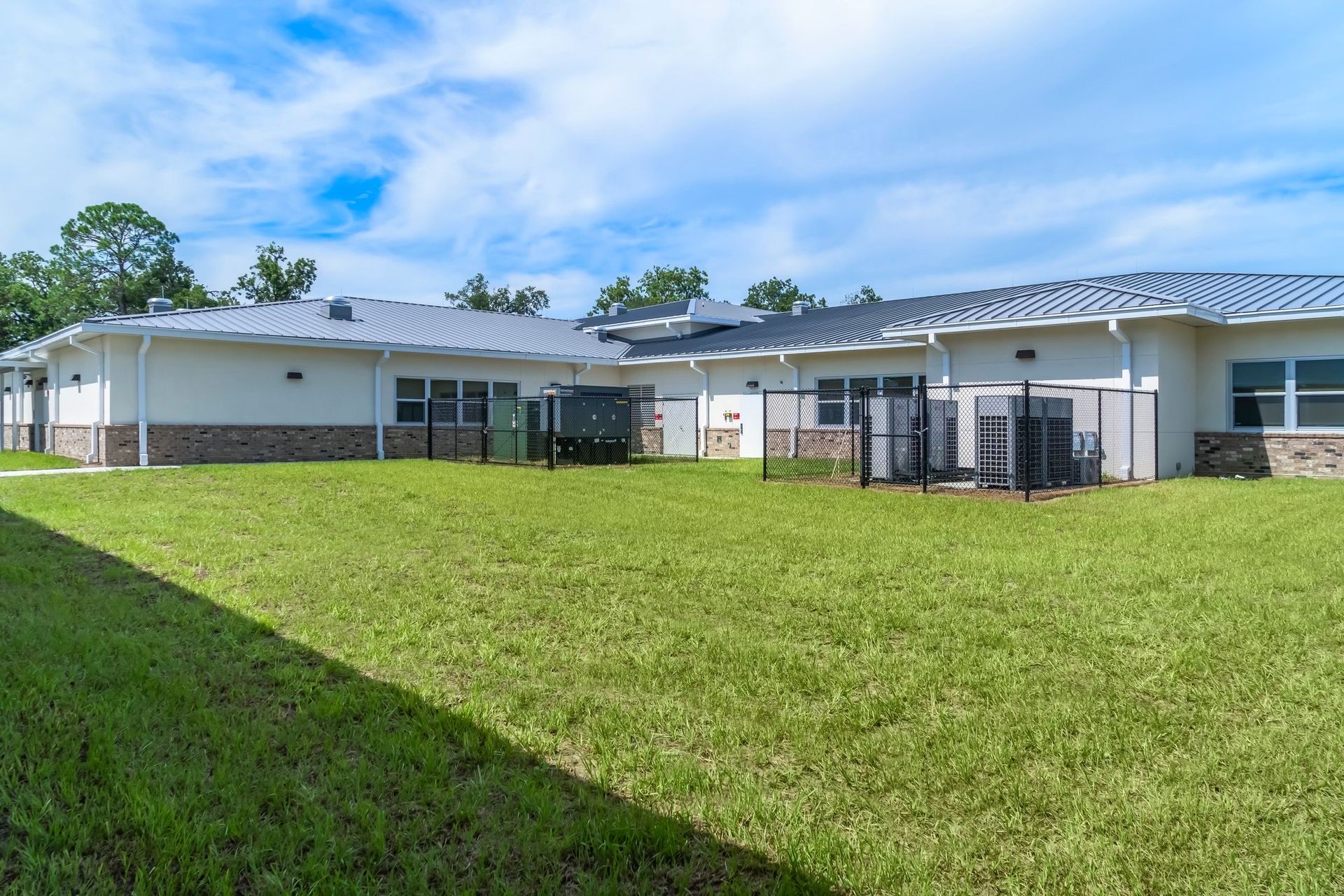 A large house with a large lawn in front of it.
