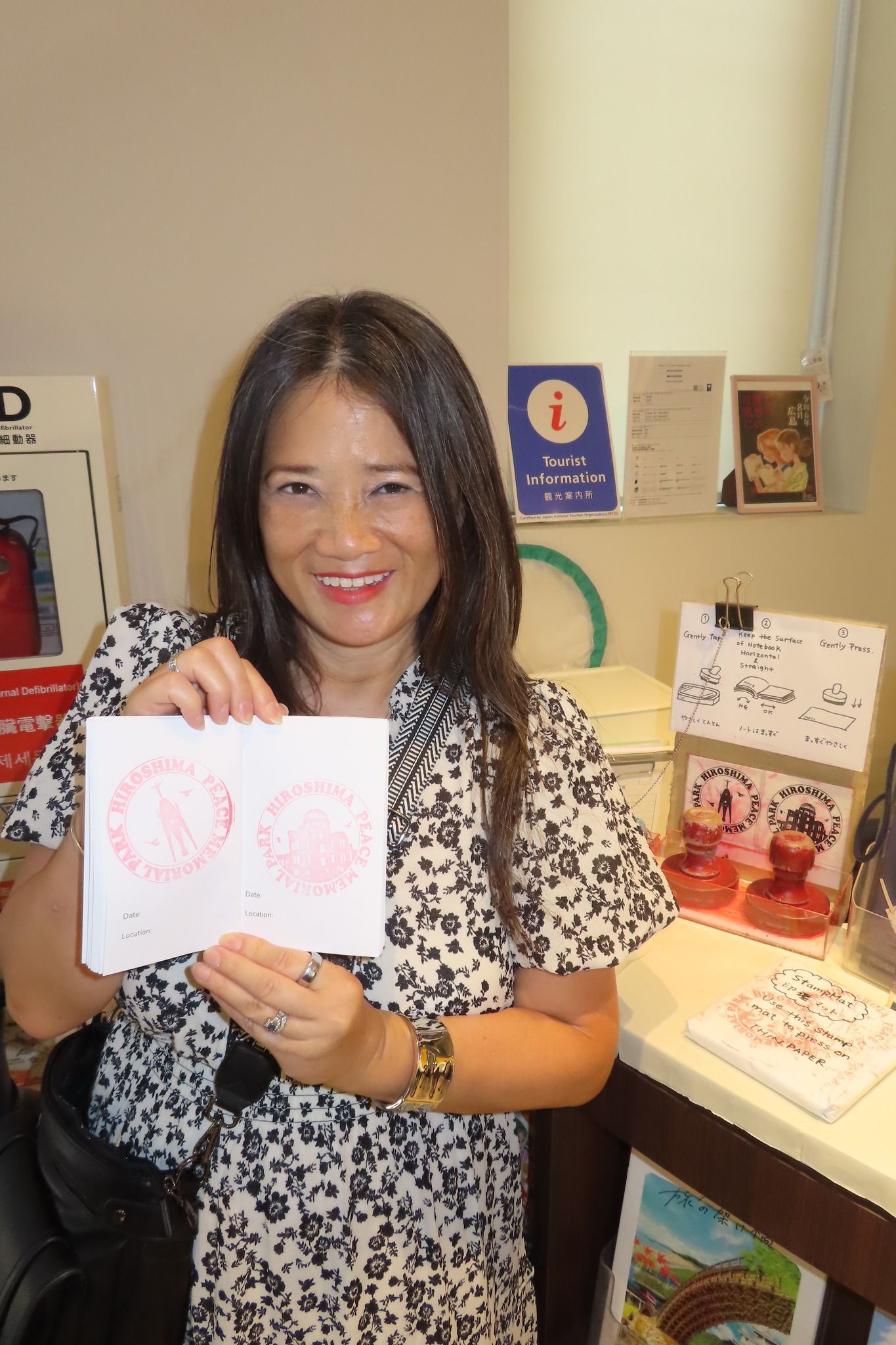 A woman is holding a piece of paper with two hearts on it